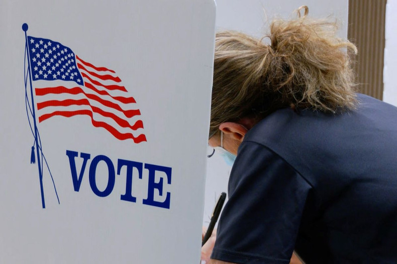 A voter marks a ballot during the primary election and abortion referendum at a Wyandotte County polling station in Kansas City, Kansas, U.S. August 2, 2022.  