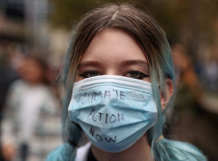 Eve Moss Ractliffe, a 14 year-old student and climate activist, wears a protective face mask with the words "Climate Action Now," while participating in a "School Strike 4 Climate" rally in Sydney, Australia, May 21, 2021.
