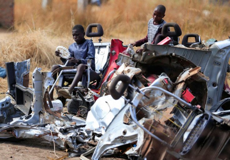 Kids play at a scrap metal collection point in Hopley, a poor settlement about 15 kilometres west of Zimbabwe's capital, Harare, Zimbabwe, July 22, 2022.