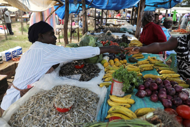 Luo shop owner Caroline Otieno sells fish that come from Lake Victoria in Kisumu county and fruits from Nandi county, at a market stall in the town of Chemase, Nandi county, Kenya August 1, 2022.