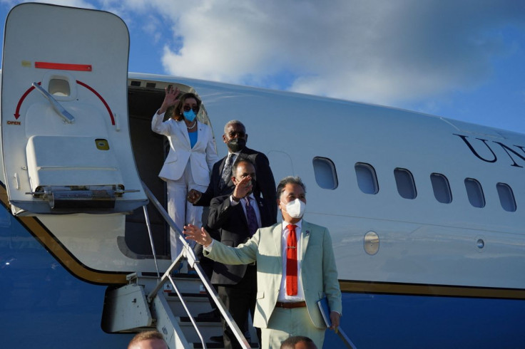 U.S. House of Representatives Speaker Nancy Pelosi waves with other members of the delegation as they board a plane before leaving Taipei Songshan Airport, in Taipei, Taiwan August 3, 2022. Taiwan Ministry of Foreign Affairs/Handout via REUTERS  