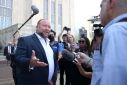 Alex Jones speaks with media after day six of trial at the Travis County Courthouse, in Austin, U.S. August 2, 2022. Briana Sanchez/Pool via REUTERS
