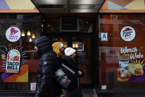 People walk by a Taco Bell and Pizza Hut, subsidiaries of Yum! Brands, Inc. in Manhattan, New York City, U.S., February 7, 2022. 