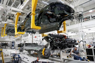 FILE PHOTO - An employee works on an assembly line at startup Rivian Automotive's electric vehicle factory in Normal, Illinois, U.S. April 11, 2022. Picture taken April 11, 2022.  