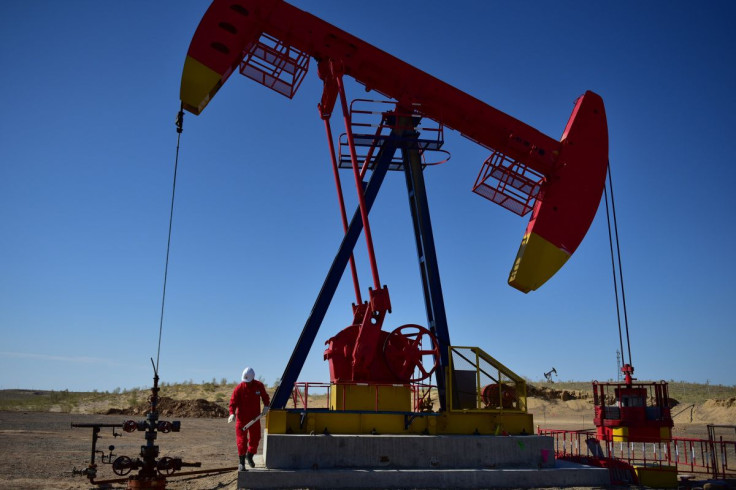 FILE PHOTO - A PetroChina worker inspects a pump jack at an oil field in Tacheng, Xinjiang Uighur Autonomous Region, China June 27, 2018.  