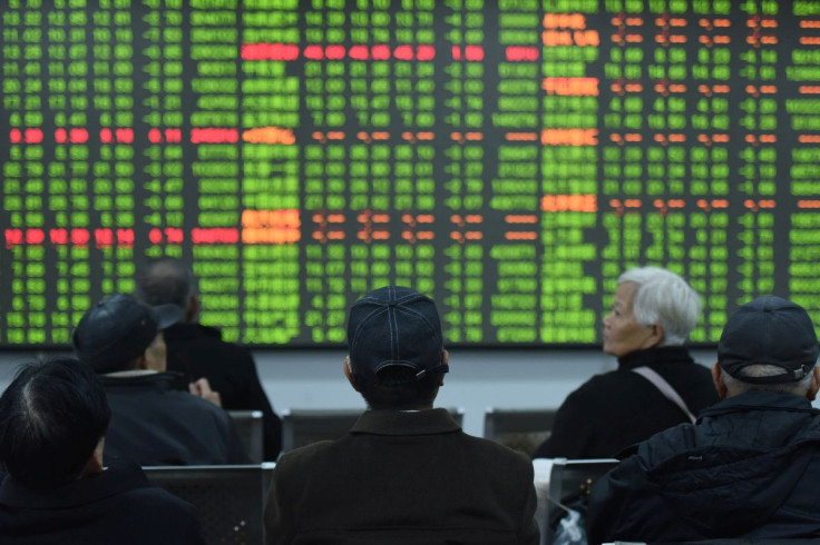 Investors sit in front of a board showing stock information at a brokerage house on the first day of trade in China since the Lunar New Year, in Hangzhou, Zhejiang province, China February 3, 2020. China Daily via REUTERS  