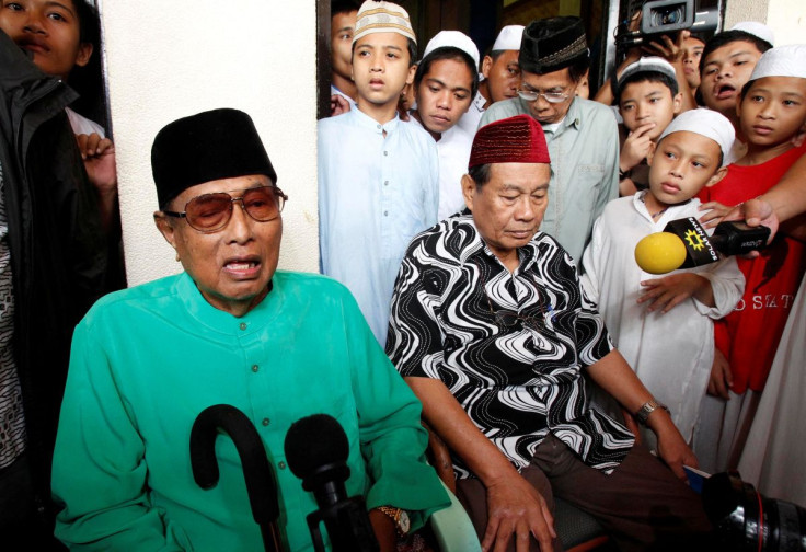 Jamalul Kiram III, a former Sultan of the Sulu region of the southern Philippines, answers questions as he sits surrounded by his followers, during a brief news conference in front of the Blue Mosque in Taguig city, south of Manila February 22, 2013.