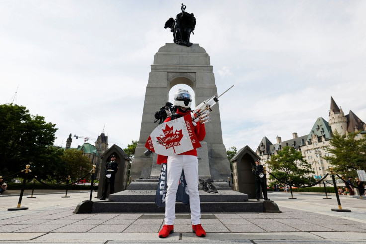 A anti-vaccine protester poses at the National War Memorial in Ottawa, Ontario, Canada June 30, 2022.