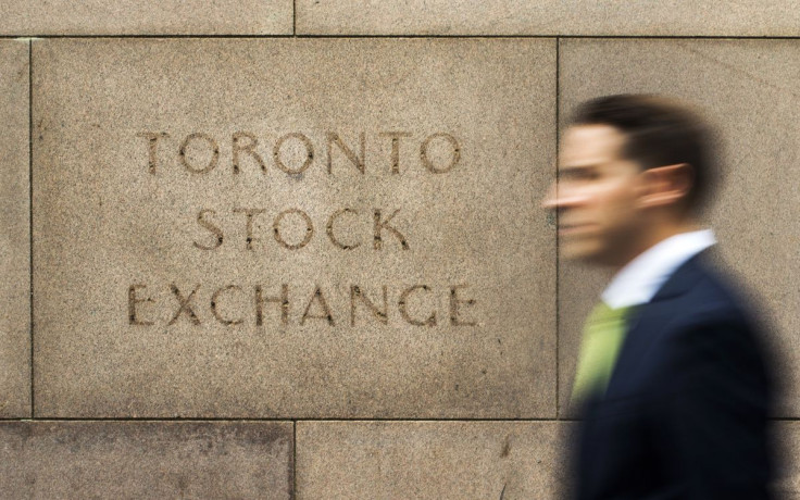 A man walks past an old Toronto Stock Exchange (TSX) sign in Toronto, June 23, 2014.   