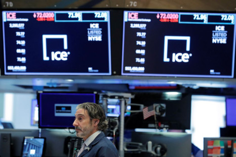  A trader walks below screens showing the current price of Intercontinental Exchange (ICE) on the floor of the New York Stock Exchange (NYSE) in New York, U.S., March 20, 2020.  