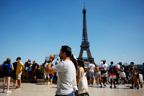 A man drinks water from a bottle at the Trocadero square near the Eiffel Tower in Paris as a heat wave hits France, August 3, 2022. 