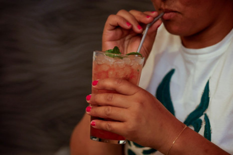 A woman drinks a mojito in Madrid, Spain, August 4, 2022. 