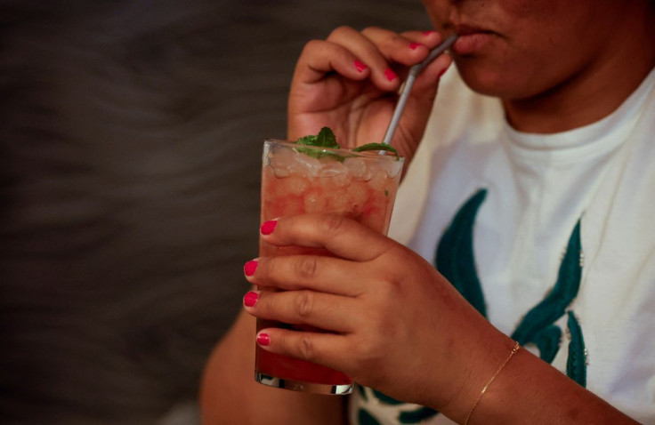 A woman drinks a mojito in Madrid, Spain, August 4, 2022.