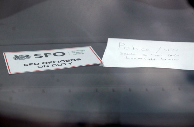 A sign is displayed in an unmarked Serious Fraud Office vehicle parked outside a building, in Mayfair, central London March 9, 2011.