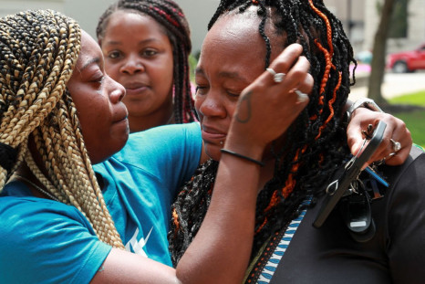 Preonia Flakes, Breonna's cousin, wipes Tamika Palmer's (Breonna Taylor mother's) tears, after the announcement that the FBI arrested and brought civil rights charges against four current and former Louisville police officers for their roles in the 2020 f