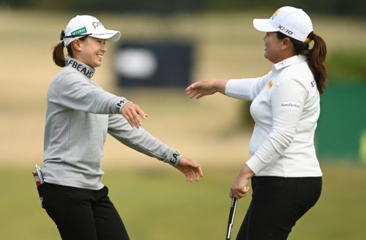 Friendly rivals: Japan's Hinako Shibuno (left) embraces South Korea's Park In-bee