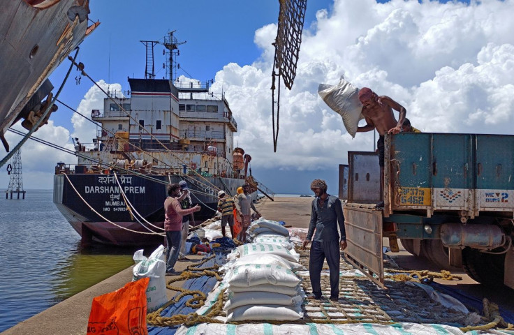 Labourers unload rice bags from a supply truck at India's main rice port at Kakinada Anchorage in the southern state of Andhra Pradesh, India, September 2, 2021. Picture taken September 2, 2021.