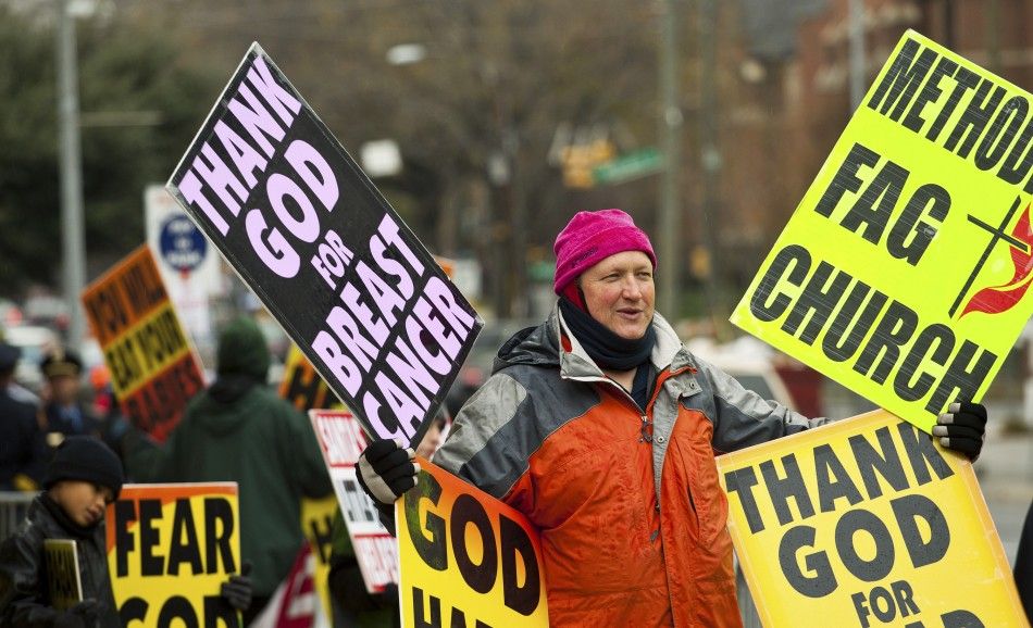 A Westboro Baptist Church member protests during the funeral for Elizabeth Edwards in Raleigh
