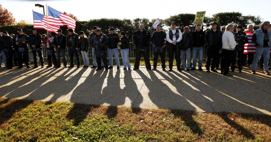 Vietnam War veterans form part of a line to block an anti-gay protest held by members of the Westboro Baptist Church at Arlington National Cemetery