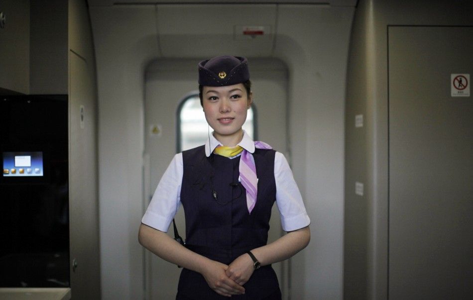 A train attendant stands inside a CRH 380A bullet train serving the newly built Shanghai-Beijing high-speed railway during its debut test at the Hongqiao Railway Station in Shanghai.