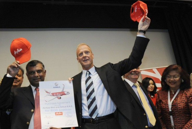 Airbus Chief Executive Officer Tom Enders and Founder of AirAsia X Fernandes pose for photographers during an announcement at the 49th Paris Air Show at the Le Bourget airport near Paris