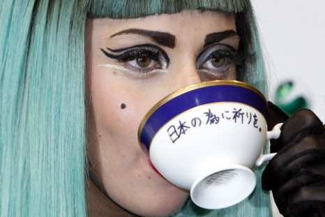 Lady Gaga holds a teacup with the words &quot;Pray for Japan&quot; written on it as she attends a news conference in Tokyo.