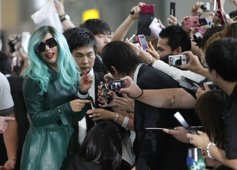 Lady Gaga signs autographs for fans upon her arrival at Narita International Airport