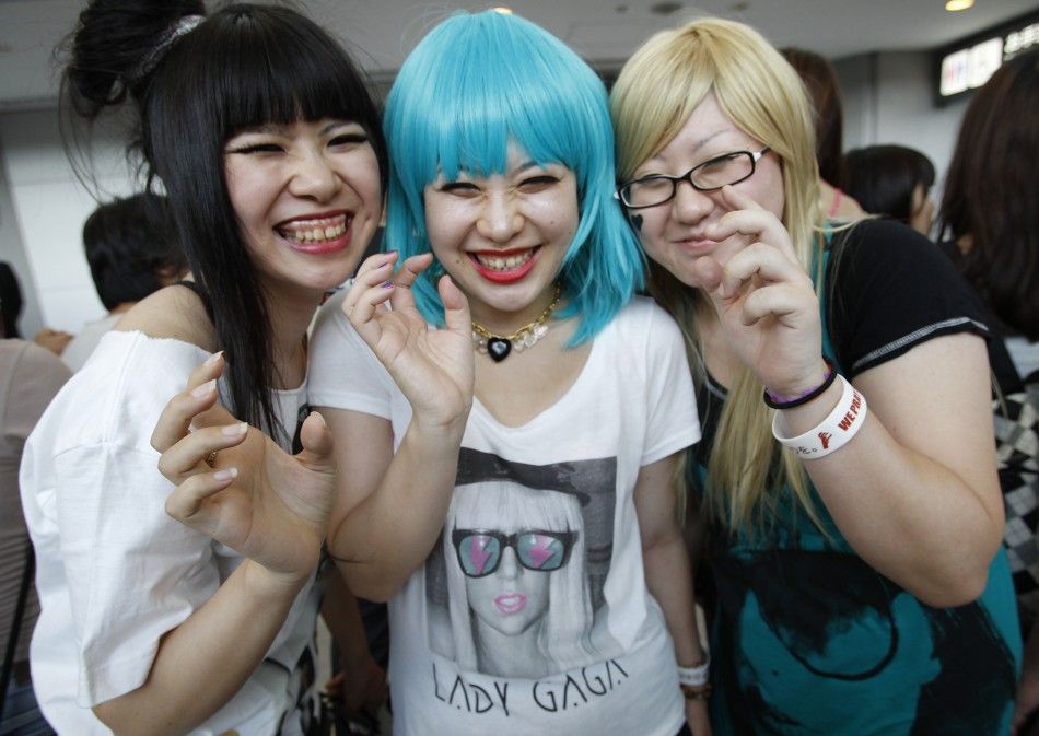 Lady Gaga fans pose for a photo as they wait for her arrival at Narita International Airport.