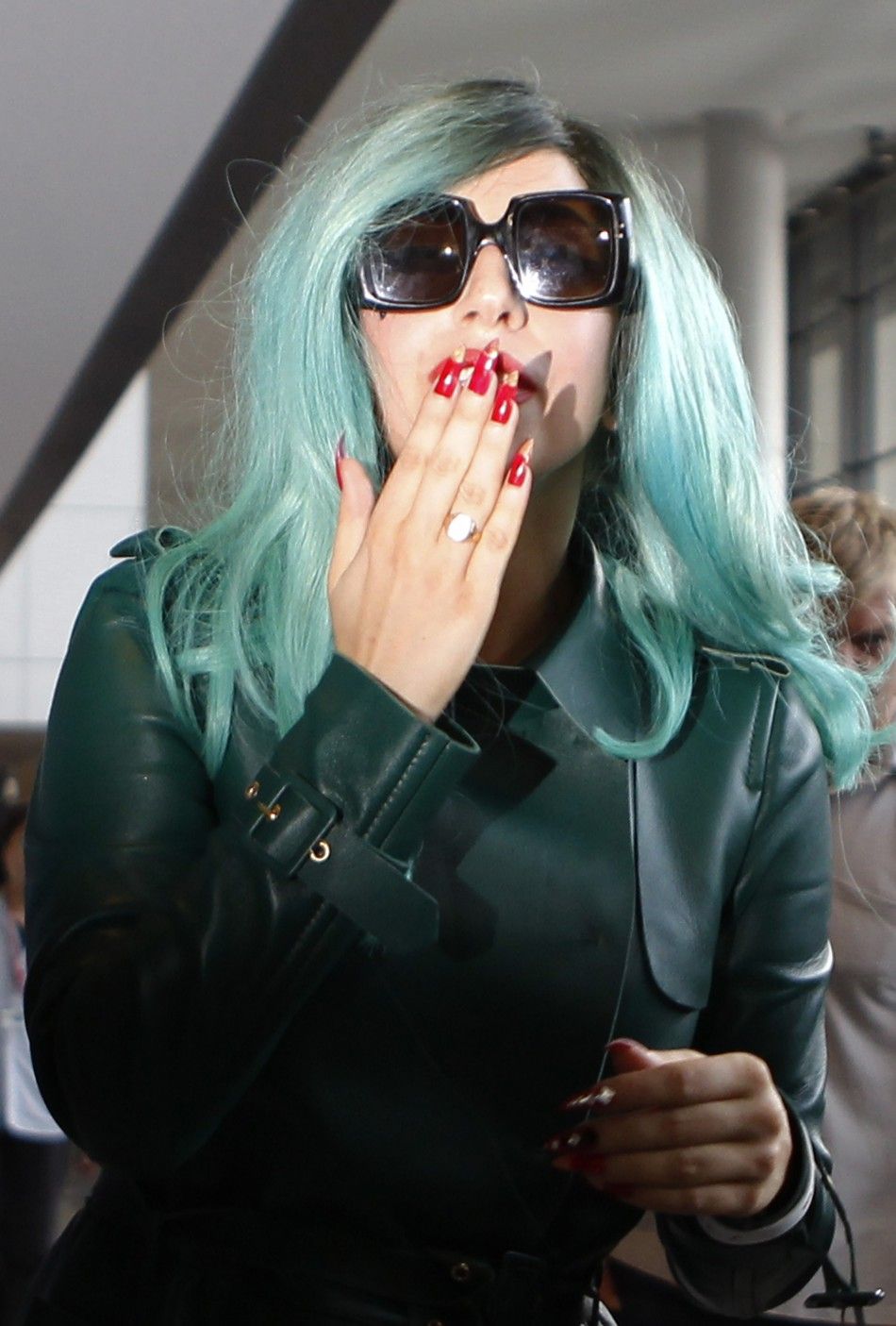 Lady Gaga blows a kiss upon her arrival at Narita International Airport