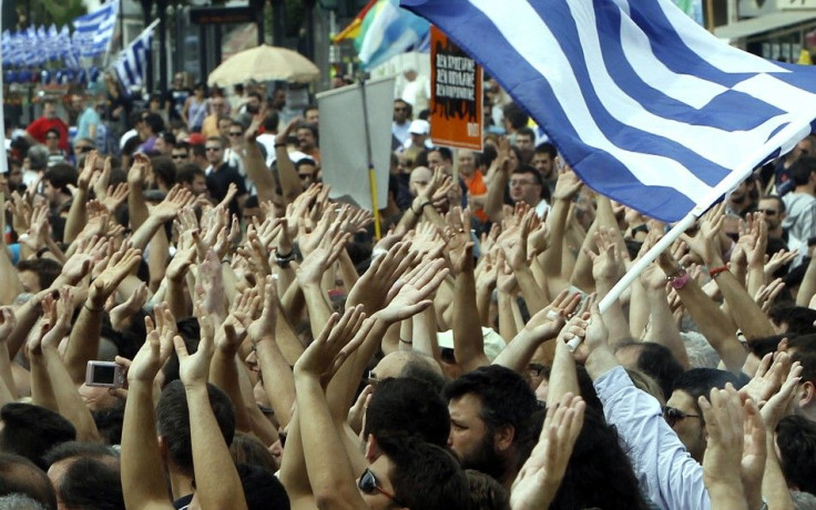 Demonstrators wave flags near the Greek parliament in Athens