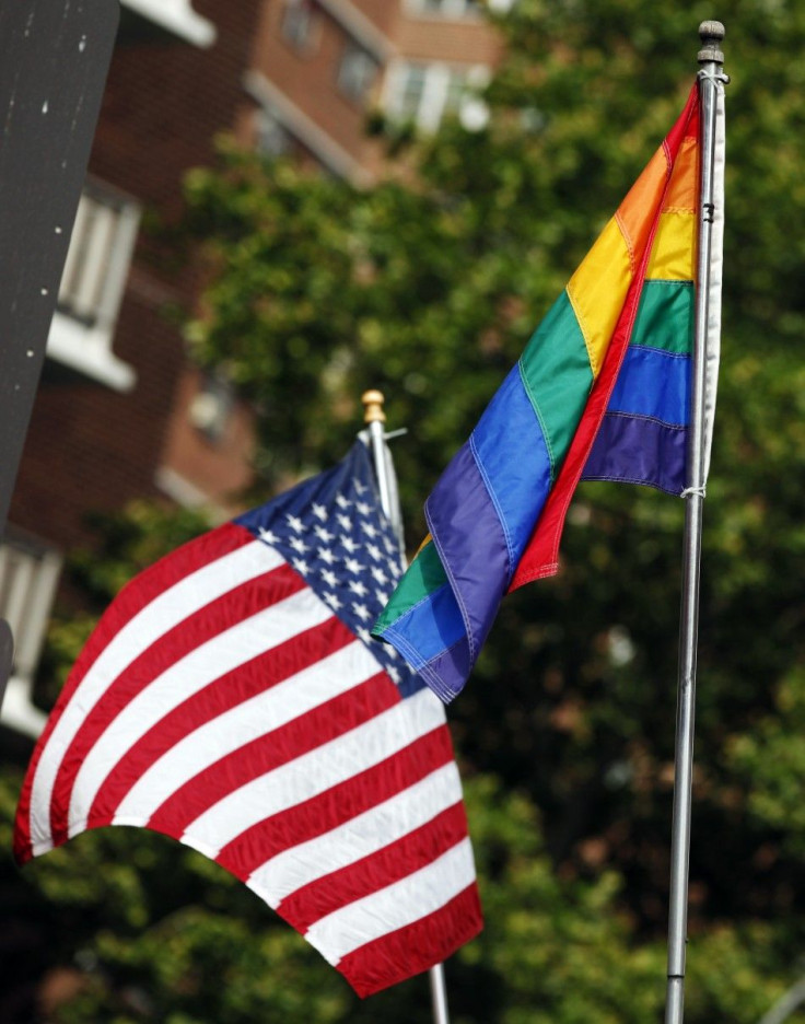 The U.S. flag is seen flying next to a rainbow flag symbolizing gay pride in New York