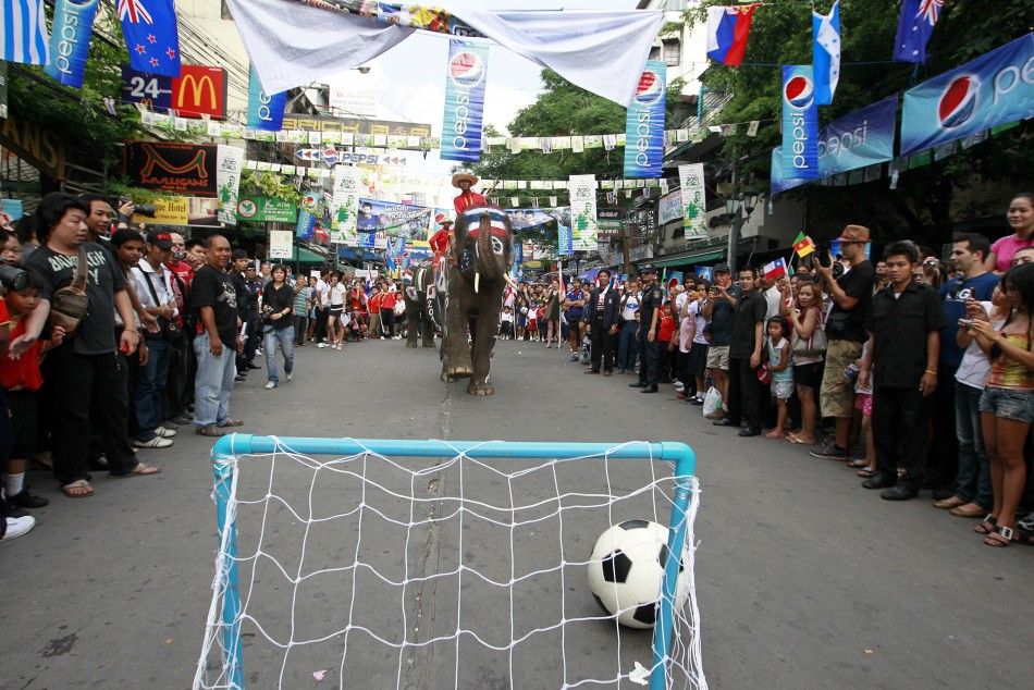 Thai people and foreign tourists gather to see elephants play soccer at Bangkok039s Khao San road
