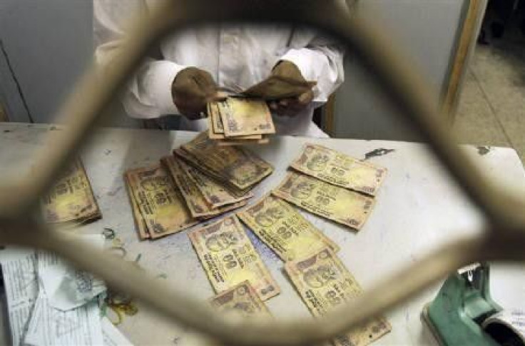 An employee sorts Indian currency notes at a cash counter inside a bank in Agartala in this February 2010 file photo. 