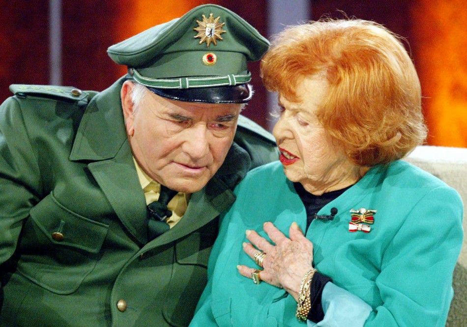 U.S. actor Peter Falk, known as legendary Inspector Columbo, is dressed as a German police officer as he speaks to German actress Brigitte Mira R during the TV show