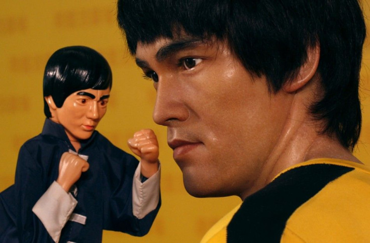 A hand puppet is placed next to a life-sized wax figure of the late Bruce Lee during an exhibition which celebrated the works of the martial arts legend at a shopping mall in Hong Kong