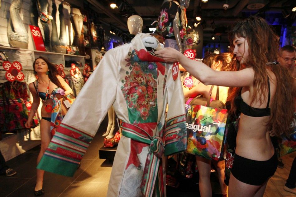 A shopper in her underwear searches for items at a Desigual store in central Prague