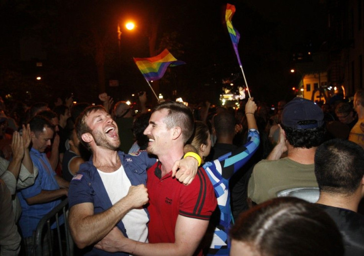 People celebrate after the New York Senate passed a bill legalizing gay marriage in New York