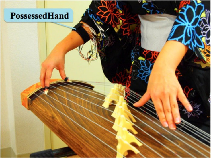 PossessedHand helps a person learn how to play musical instruments such as the koto