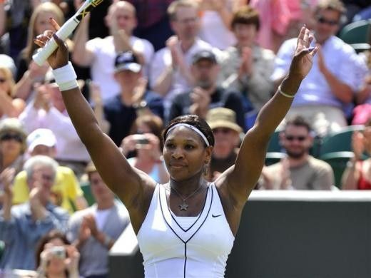 Serena Williams of the U.S. waves after defeating Simona Halep