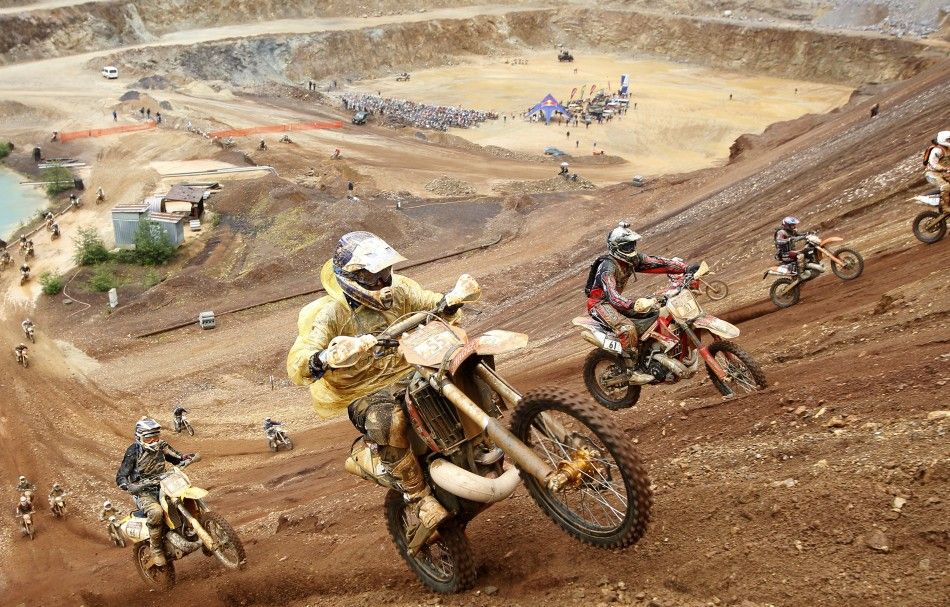 Motocross riders participate in the 039Red Bull Hare Scramble039 race during Erzberg Rodeo near the village of Eisenerz