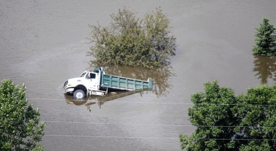 A dump truck is seen in flood waters in Sawyer, North Dakota, near the Souris River