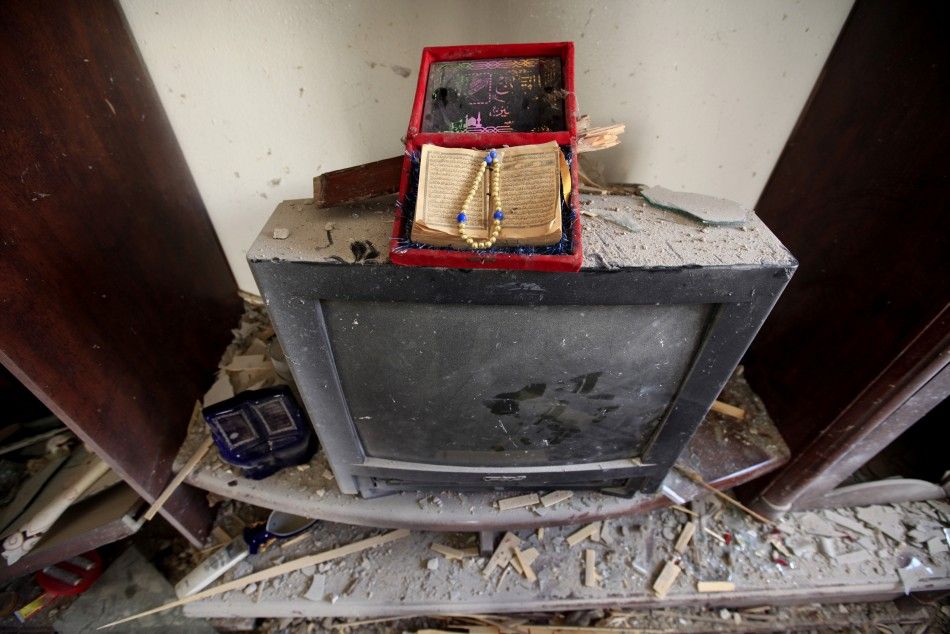 A copy of the Koran sits on top of a television after a rocket strike on a house in the centre of the rebel-held city of Misrata