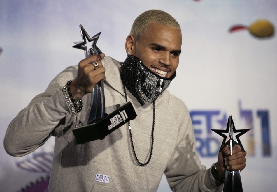 Singer Chris Brown poses for photographers with two of the four BET Award he won at the 2011 BET Awards in Los Angeles, California, June 26, 2011.