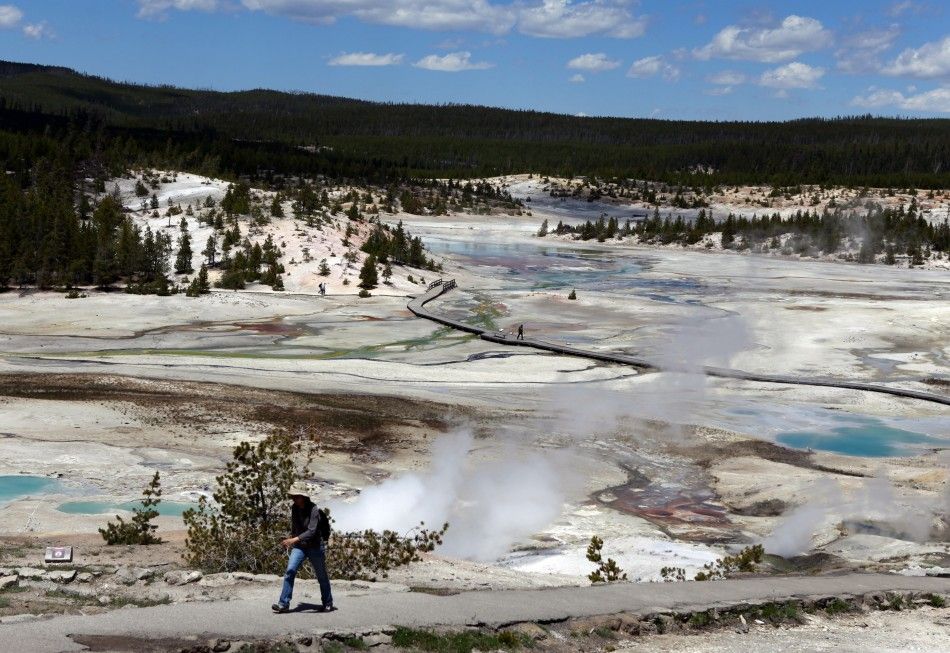 A hiker walks out of the Norris Geyser Basin