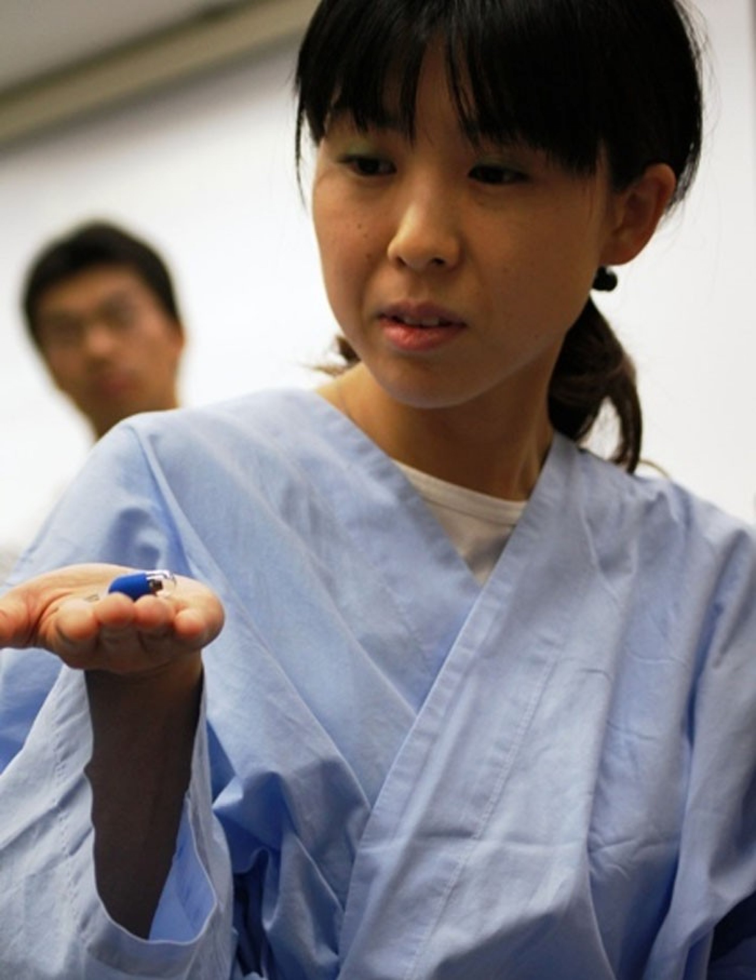 A nurse holds the pill-size remote-controlled endoscope Mermaid in her palm