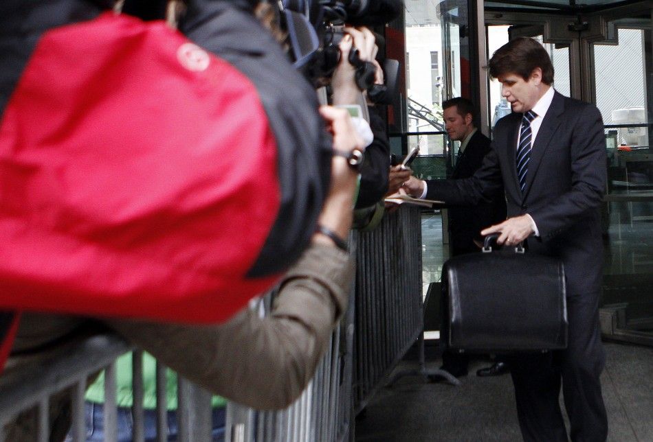Blagojevich signs an autograph as he leaves federal court during his second trial in Chicago
