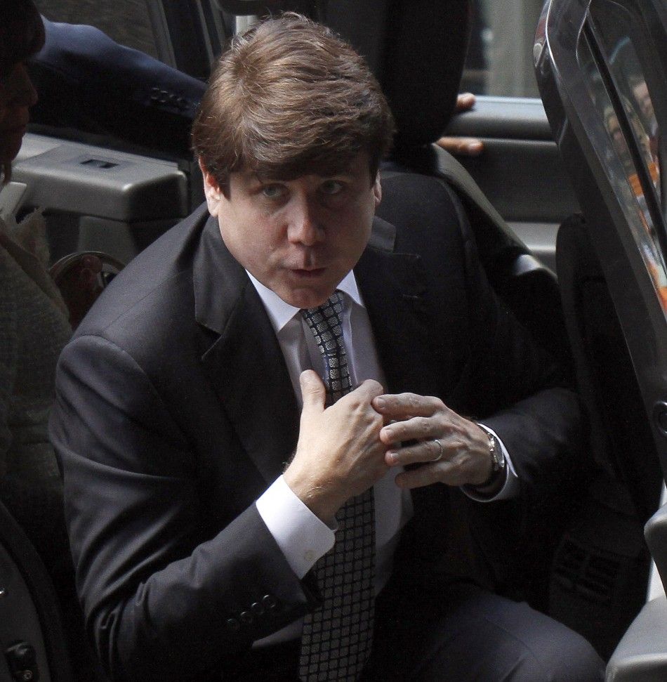 Former Illinois Governor Rod Blagojevich straightens his tie as he enters the Dirksen Federal building to hear the verdict on his second corruption trial in Chicago