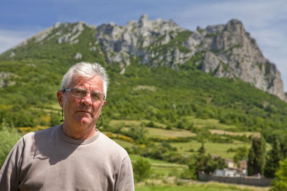 Jean-Pierre Delord, mayor of the village of Bugarach, poses in front of the peak, the high point of the Corbieres massif,