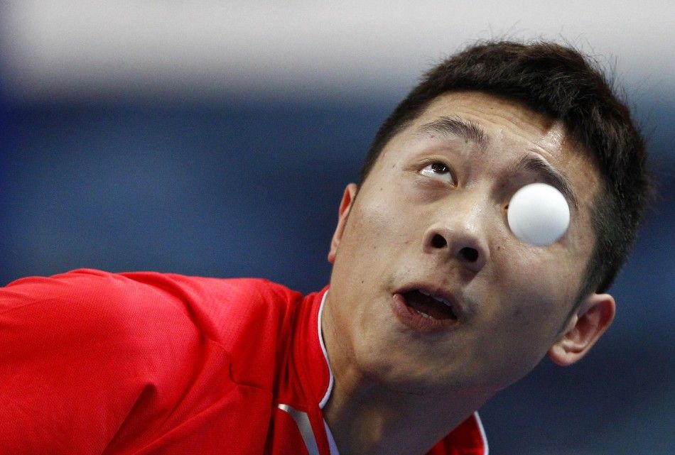 China039s Xu eyes the ball as he serves against Boll of Germany during their table tennis game at the Volkswagen 2011 China vs. World Team Challenge event in Shanghai