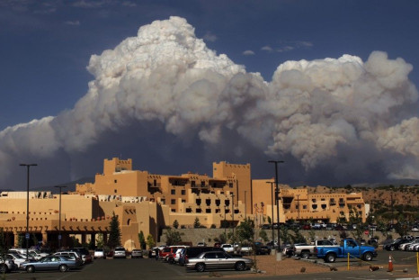 Smoke from the Pacheco Canyon Wildfire rises behind the Buffalo Thunder Casino in Pojoaque, New Mexico